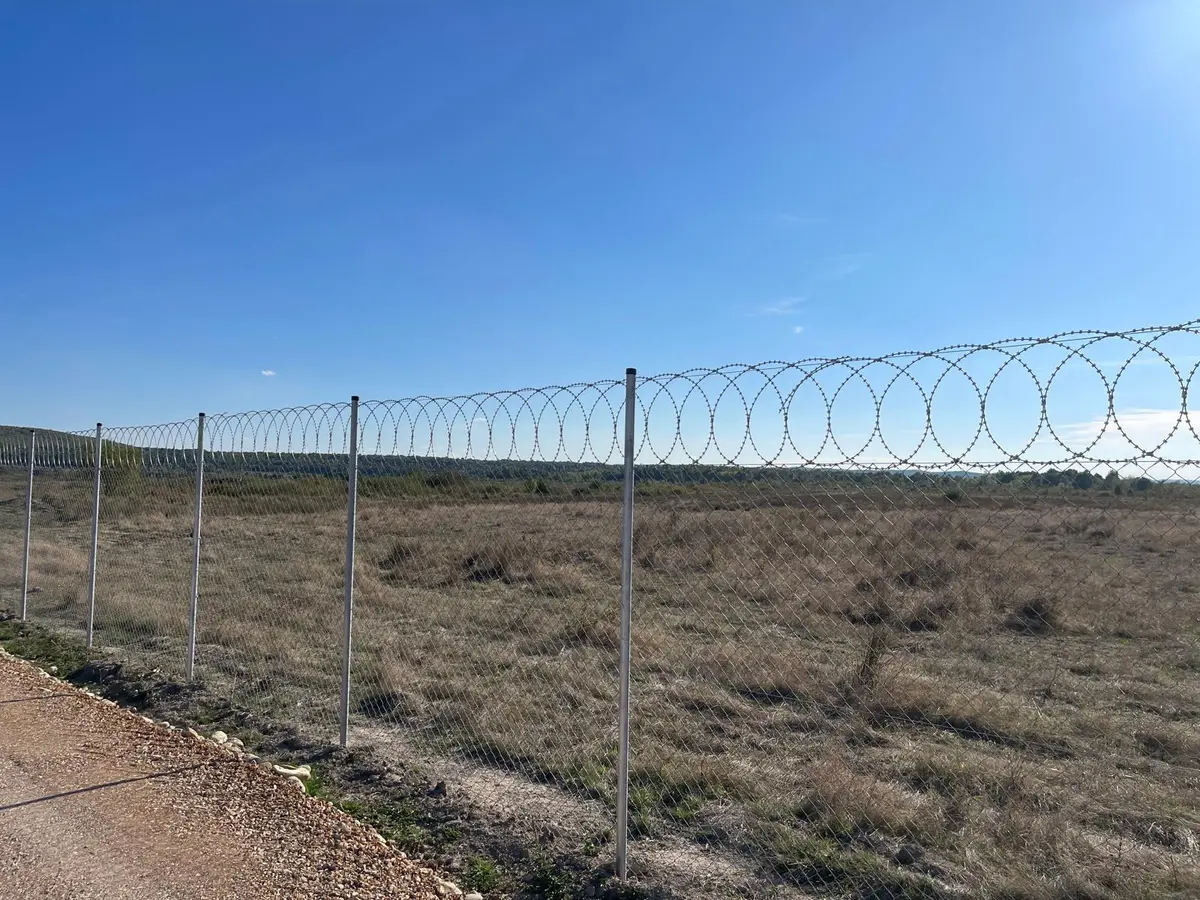 Gard de securitate cu plasă împletită zincată Flexyfort, parc fotovoltaic LPV – de-a lungul aleii, teren cu iarbă